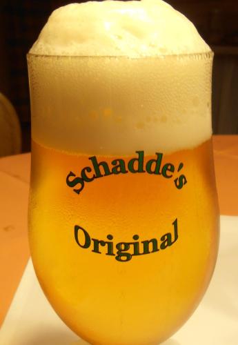 a glass of beer sitting on a table at Gasthaus Schadde in Vlotho