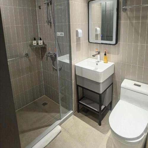 a bathroom with a shower and a sink and a toilet at Jinjiang Inn Tianjin Station Jinwan Square in Tianjin
