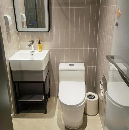 a bathroom with a white toilet and a sink at Jinjiang Inn Tianjin Station Jinwan Square in Tianjin