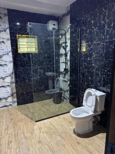 a bathroom with a toilet and a shower at D5 future homes hotel & apartment in Benin City