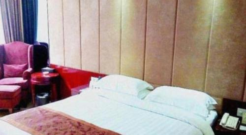 Ένα ή περισσότερα κρεβάτια σε δωμάτιο στο Forstar Hotel Renbei subbranch