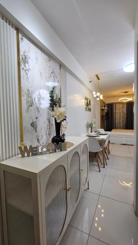 a living room with a counter and a dining room at Hotel - Style Studio with balcony Davao City in Davao City