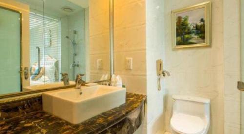 a bathroom with a sink and a toilet at Datong Hotel in Datong