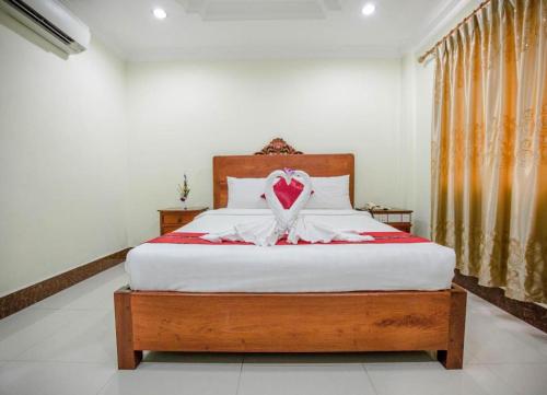 Кровать или кровати в номере Vy Chhe Hotel