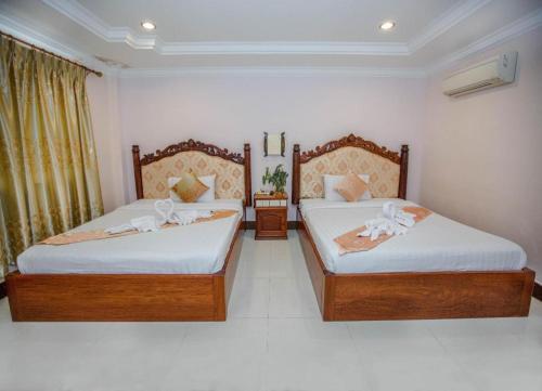 Кровать или кровати в номере Vy Chhe Hotel