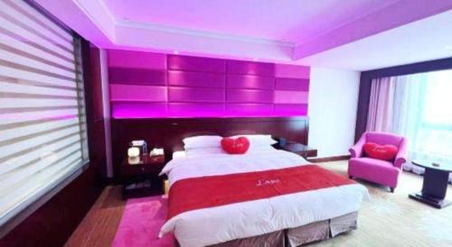 a bedroom with a large bed with purple lighting at Hohhot Hai Liang Plaza Hotel in Hohhot