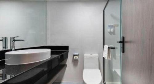 a bathroom with a sink and a toilet at Movie Star Hotel in Guangzhou