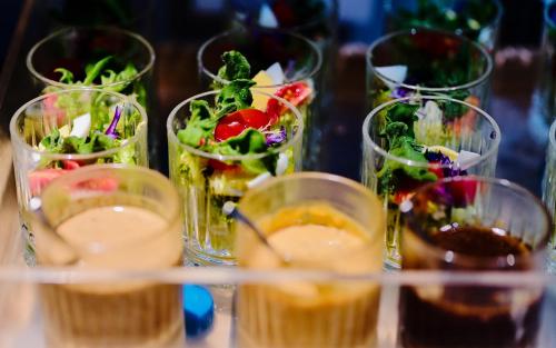 a group of glass cups filled with different types of food at Atour Light Hotel Shenzhen Nanshan Nanyou Clothing City in Shenzhen