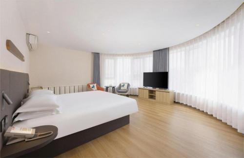 Postel nebo postele na pokoji v ubytování Jinjiang Inn - Xishan Road