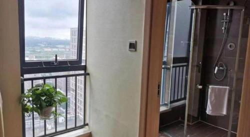 a bathroom with a shower and a plant on a balcony at IU Hotel Chengdu High-Tech Zone Longhu Times Street in Chengdu
