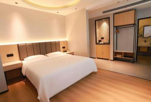 Ένα ή περισσότερα κρεβάτια σε δωμάτιο στο GreenTree Inn Maanshan Hanshan District Jiuwu Square Hotel
