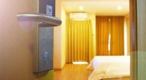 a door handle in a room with a bedroom at IU Hotel Chengdu High-Tech Zone Longhu Times Street in Chengdu