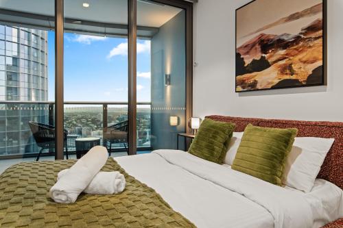 a bedroom with a large bed with a view at Sky Living & River Views in Queens Wharf Residences in Brisbane