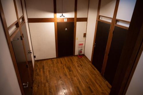 an empty hallway with two doors and wood floors at Zenya-Nakano in Nakano