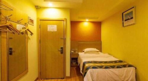 a hotel room with a bed and a bathroom at Shell Hefei Luyang District Sipai Building Subway Station Hotel in Hefei