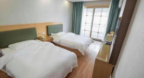 a hotel room with two beds and a window at Shell Hefei Luyang District Sipai Building Subway Station Hotel in Hefei