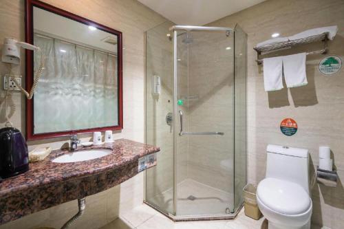 a bathroom with a shower and a sink and a toilet at GreenTree Inn Wuxi Guangrui Road Hotel in Wuxi