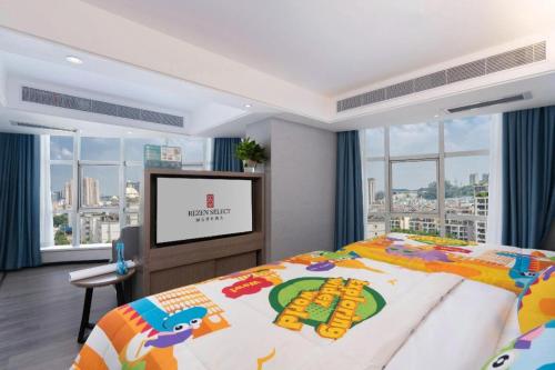 a bedroom with a bed and a flat screen tv at Nanning Prince Hotel in Nanning
