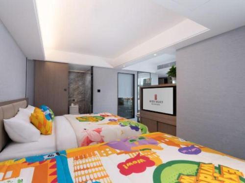 a bedroom with a bed and a flat screen tv at Nanning Prince Hotel in Nanning