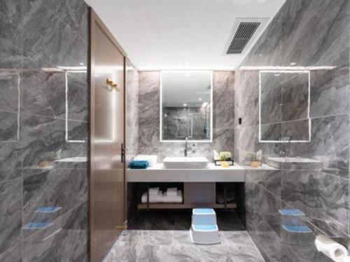 ein Badezimmer mit Waschbecken und Spiegel in der Unterkunft Nanning Prince Hotel in Nanning