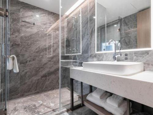 a bathroom with a sink and a shower at Nanning Prince Hotel in Nanning