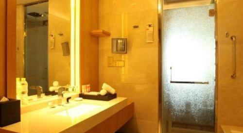 a bathroom with a sink and a shower at Dusit D2 Binhu Changzhou Hotel in Changzhou