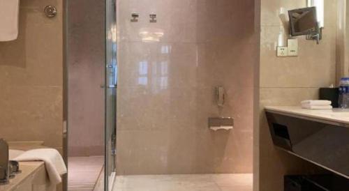 a bathroom with a shower with a glass door at Dusit D2 Binhu Changzhou Hotel in Changzhou