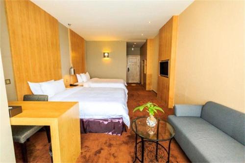 a hotel room with a bed and a couch at The Art Hotel in Shenzhen