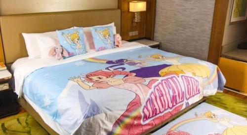 a bedroom with a large bed with cartoon characters on it at Dusit D2 Binhu Changzhou Hotel in Changzhou
