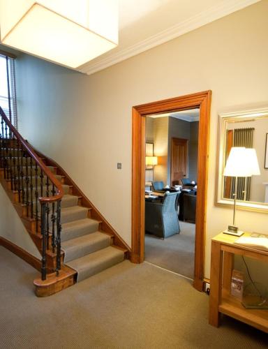 a room with a staircase and a living room at Craigatin House & Courtyard in Pitlochry