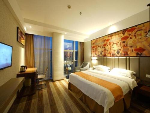 a hotel room with a large bed and a desk at GreenTree Inn Fujian Fuzhou Software Park River View Business Hotel in Fuzhou