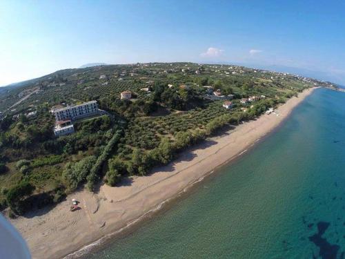 an island in the ocean next to a beach at De La Plage Hotel Koroni in Koroni