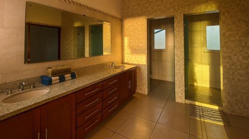 a bathroom with a sink and a mirror at MARACUYA at Limoncito Beach in Limoncito Hill