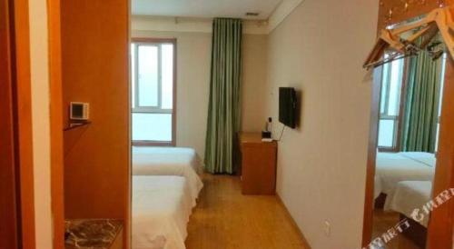 a hotel room with two beds and a window at GreenTree Inn Hefei Huangshan Road Daxidi 1912 Express Hotel in Hefei