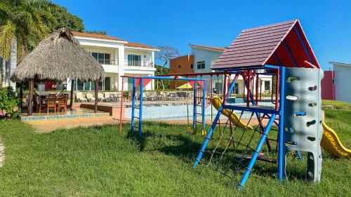 a playground in a yard next to a house at MARACUYA at Limoncito Beach in Limoncito Hill