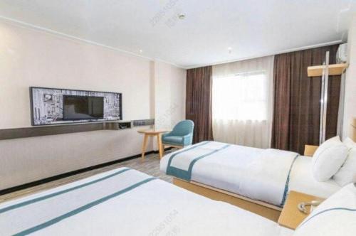 Ένα ή περισσότερα κρεβάτια σε δωμάτιο στο City Comfort Inn Beiliu Bus Terminal