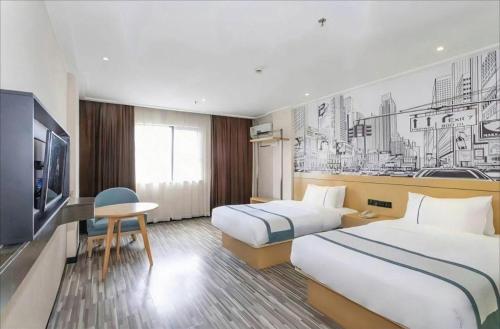 Ένα ή περισσότερα κρεβάτια σε δωμάτιο στο City Comfort Inn Beiliu Bus Terminal