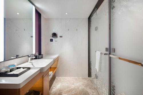 a bathroom with a sink and a shower at Hampton by Hilton Zhuhai Doumen in Zhuhai