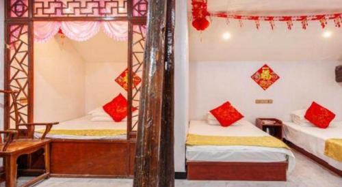 a bedroom with two bunk beds with red pillows at Pingyao Yufengheng Hotel in Pingyao