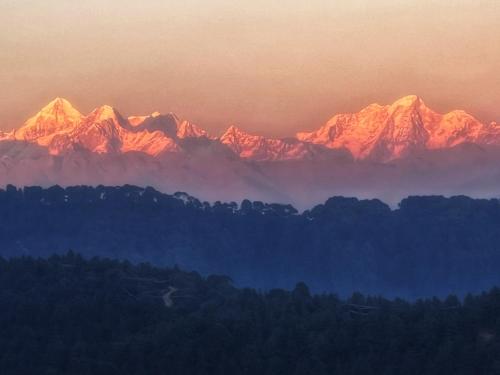 a view of a mountain range at sunset at Joy Source Resort in Kathmandu