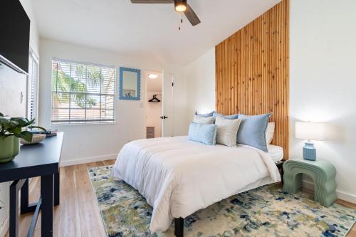 a bedroom with a large bed and a window at 2BR Beach Getaway - Pool Gym Near Space Coast in Indialantic