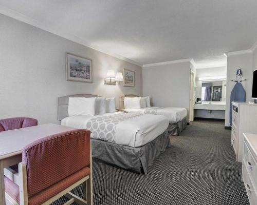 a hotel room with two beds and a television at Econo Lodge Van Horn in Van Horn
