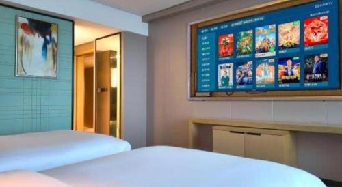 Postel nebo postele na pokoji v ubytování Echarm Hotel Yangjiang Baili Plaza