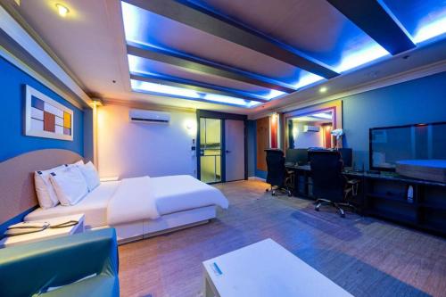 a hotel room with a large bed and a desk at Hotel Head-One in Uijeongbu