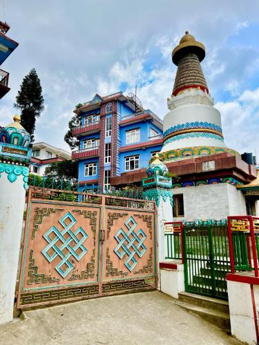 a building with a gate in front of a building at Joy Source Resort in Kathmandu