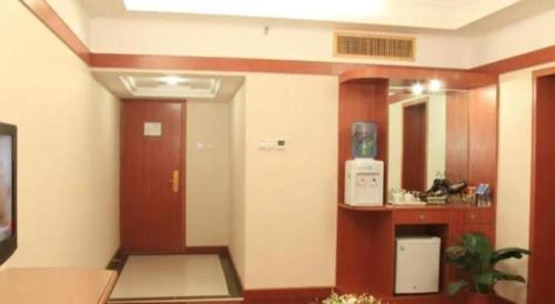 a room with a hallway with a door and a mirror at Golden Lustre Hotel in Shenzhen