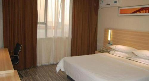 a bedroom with a white bed and a window at City Comfort Inn Foshan Shunde Daliang Qinghui Garden Xinsong in Shunde