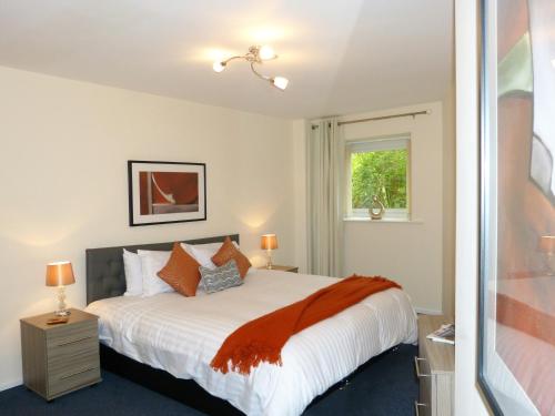 a bedroom with a large bed and a window at The Sawmills in Carlisle