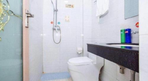 a bathroom with a shower and a toilet and a sink at shenzhen kaixin Hotel in Shenzhen