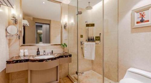 a bathroom with a sink and a shower at Hefei Parkview Hotel in Hefei